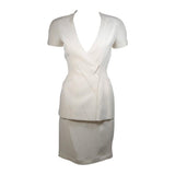 This Thierry Mugler skirt suit is composed of a white material. The jacket has a center front closures with silver hardware. The skirt has a classic pencil silhouette with zipper closure. In excellent vintage condition. Made in France.