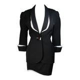 This fabulous Thierry Mugler ensemble is comprised of medium weight wool gabardine with a dramatic sculpted white lapel and cuff detail in white satin. Fitted waist has a single Tri-color abstract square button echoing the white edges of the lapels and cuffs. Medium density shoulder pads. Fitted skirt with a hidden zipper and covered satin snap at back with 3-D white detail at the hem.