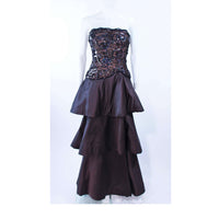ARNOLD SCAASI 1980s Black & Gunmetal Lace Iridescent Sequin Tiered Gown Size  4-6. This Arnold Scaasi design is composed of black satin. Features a lace bodice with iridescent sequin applique. The tiered style skirt has a horse hair trim. There is an boned interior and a center back zipper closure. In excellent vintage condition.