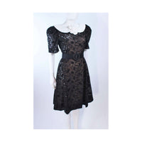 ARNOLD SCAASI Belle De Jour Black Sequin Lace Cocktail Dress Size 10. This Arnold Scaasi cocktail dress is composed of black lace with sequin embellishment. Features a center back zipper closure and contrast white collar with puff sleeves. In excellent vintage condition.