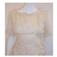 CHRISTIAN DIOR 1988 Cream Blouse & Skirt Set. This is a cream blouse and skirt set by Christian Dior Haute Couture, from 1988. The blouse and skirt are attached at the waist line by tiny couture snaps, however it can be worn as two separate pieces easily. Provenance: Betsy Bloomingdale 
