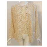 Chanel 2 pc Cream & Yellow Silk Blouse and Tank Set.This is a two piece cream and yellow print silk blouse and tank set by Chanel, from the 1990's. The blouse has five gold logo buttons down the front and two open patch pockets. The tank has a scoop neckline with top stitching detail. Measurements:BlouseLength(Shoulder to hem): 27"Shoulder to shoulder: 16"Sleeve: 22 1/2"Bust: 40"Waist: 40"Hip: 42"TankLength: 22 1/2"Bust: 38"Waist: 39"Hip: 40"