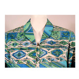 EMILIO PUCCI 1970s Mint Green & White Cotton Print Jacket. Made exclusively for Saks Fifth Avenue by Emilio Pucci Italy. Comprised of a blue, green and white abstract print cotton, with the signature "Emilio" throughout the pattern. The front closure snaps all the way down on a separate panel. There is no lining.Size: 12Measurements: Bust: 38"Sleeve: 21"Shoulder to shoulder: 17"Length: 26"