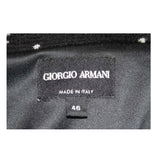 This Giorgio Armani jacket is composed of a wool blend in a black with white speckle textile print. There are front pockets, front button closures, and piping trim. In excellent condition. Made in Italy.
