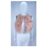 This Givenchy jacket is composed of a soft mauve pink marabou and features rhinestone jewel accents at the shoulders. The base is composed of silk and features a silk organza interior. In excellent condition.