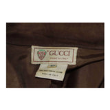 This Gucci jacket is composed of a supple khaki brown hue suede. Features center front button closures, and shoulder pads. In excellent vintage condition.