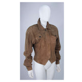 This Gucci jacket is composed of a supple khaki brown hue suede. Features center front button closures, and shoulder pads. In excellent vintage condition.