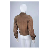 This Gucci jacket is composed of a supple khaki brown hue suede. Features center front button closures, and shoulder pads. In excellent vintage condition.