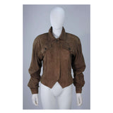 This Gucci jacket is composed of a supple khaki brown hue suede. Features center front button closures, and shoulder pads. In excellent vintage condition.