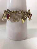 ST. JOHN Gold Toned Charm Toggle Bracelet with Hearts and Red Rhinestones
