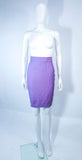 This Thierry Mugler skirt suit is composed of a lavender/purple hue fabric. Features a classic Mugler silhouette with nipped waist and curved bust-line to neckline design. The classic pencil style skirt features a zipper closure. In good vintage pre-owned condition (some signs of wear due to age) the skirt shows signs of alterations. Made in France.
