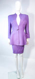 This Thierry Mugler skirt suit is composed of a lavender/purple hue fabric. Features a classic Mugler silhouette with nipped waist and curved bust-line to neckline design. The classic pencil style skirt features a zipper closure. In good vintage pre-owned condition (some signs of wear due to age) the skirt shows signs of alterations. Made in France.