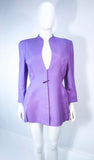 This Thierry Mugler skirt suit is composed of a lavender/purple hue fabric. Features a classic Mugler silhouette with nipped waist and curved bust-line to neckline design. The classic pencil style skirt features a zipper closure. In good vintage pre-owned condition (some signs of wear due to age) the skirt shows signs of alterations. Made in France.