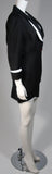 This fabulous Thierry Mugler ensemble is comprised of medium weight wool gabardine with a dramatic sculpted white lapel and cuff detail in white satin. Fitted waist has a single Tri-color abstract square button echoing the white edges of the lapels and cuffs. Medium density shoulder pads. Fitted skirt with a hidden zipper and covered satin snap at back with 3-D white detail at the hem.