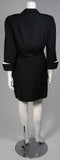 This fabulous Thierry Mugler ensemble is comprised of medium weight wool gabardine with a dramatic sculpted white lapel and cuff detail in white satin. Fitted waist has a single Tri-color abstract square button echoing the white edges of the lapels and cuffs. Medium density shoulder pads. Fitted skirt with a hidden zipper and covered satin snap at back with 3-D white detail at the hem.