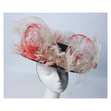 This Saks Fifth Ave. hat is composed of a black base with elastic piece for wear. Features white and red ostrich feathers. In excellent vintage condition.