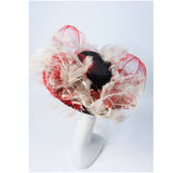 This Saks Fifth Ave. hat is composed of a black base with elastic piece for wear. Features white and red ostrich feathers. In excellent vintage condition.