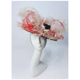 This Saks Fifth Ave. hat is composed of a black base with elastic piece for wear. Features white and red ostrich feathers. In excellent vintage condition.