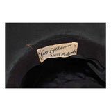 This Saks Fifth Ave. hat is composed of a black base with elastic piece for wear. Features white and red ostrich feathers. In excellent vintage condition.