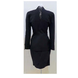 This THIERRY MUGLER skirt suit is composed of a black polyester and lace fabric. Features a classic Mugler silhouette with nipped waist and curved bust-line to neckline design. The jacket has front snap closures, rounded shoulders, and lace panels at the neck, back, and sleeves. The classic pencil style skirt features a zipper closure. In good vintage pre-owned condition. Made in France.Measurements in Inches:JacketBust: 38 Waist: 30 SkirtWaist: 27Hip: 38Length: 22