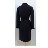 THIERRY MUGLER Silver and Rhinestone Hardware Skirt Suit Size 40. This THIERRY MUGLER skirt suit is composed of a black polyester fabric. Features a classic Mugler silhouette with nipped waist and curved bust-line to neckline design. The jacket has front snap closures, rounded shoulders, and silver and rhinestone hardware detail. The classic pencil style skirt features a zipper closure. In good vintage pre-owned condition. Made in France.Measurements in Inches:JacketBust: 38Waist: 29SkirtWaist: 26Hip: 40Len