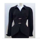 THIERRY MUGLER Silver and Rhinestone Hardware Skirt Suit Size 40. This THIERRY MUGLER skirt suit is composed of a black polyester fabric. Features a classic Mugler silhouette with nipped waist and curved bust-line to neckline design. The jacket has front snap closures, rounded shoulders, and silver and rhinestone hardware detail. The classic pencil style skirt features a zipper closure. In good vintage pre-owned condition. Made in France.Measurements in Inches:JacketBust: 38Waist: 29SkirtWaist: 26Hip: 40Len