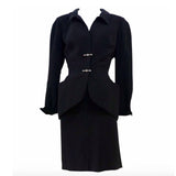 THIERRY MUGLER Silver and Rhinestone Hardware Skirt Suit Size 40. This THIERRY MUGLER skirt suit is composed of a black polyester fabric. Features a classic Mugler silhouette with nipped waist and curved bust-line to neckline design. The jacket has front snap closures, rounded shoulders, and silver and rhinestone hardware detail. The classic pencil style skirt features a zipper closure. In good vintage pre-owned condition. Made in France.Measurements in Inches:JacketBust: 38Waist: 29SkirtWaist: 26Hip: 40Len