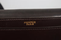 HERMÈS Dark Brown Leather Crossbody Bag with Gold Buckle and Adjustable Strap