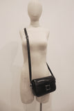 HERMÈS Black Leather Crossbody Bag with Silver Buckle and Adjustable Strap