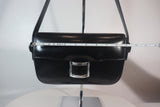 HERMÈS Black Leather Crossbody Bag with Silver Buckle and Adjustable Strap