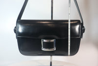 HERMÈS Black Leather Crossbody Bag with Silver Buckle and Adjustable Strap