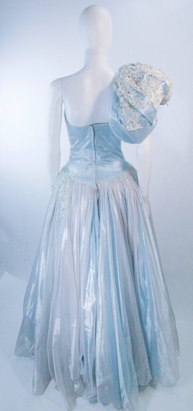 nolan miller blue beaded dress Blue beaded gown designed by Nolan Miller worn by Elizabeth Taylor. . . . #nolanmiller #elizabethtaylor #80sfashion #glamour #joancollins hollywood oldhollywood vintage barrymanilow collector instamood elizabethtayloraidsfoundation fashion