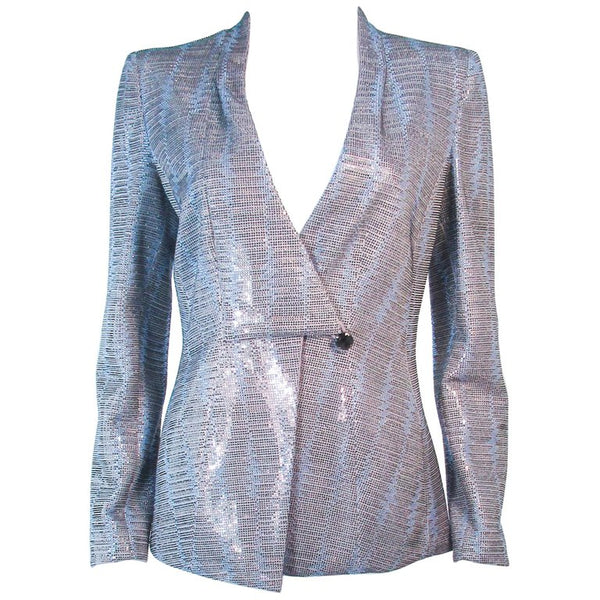 This Giorgio Armani is composed of a blue silk blend with rhinestone applique in different hues. Features center front snap button closures with neckline drape. In excellent pre-owned condition.