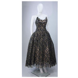 This Scaasi gown is composed of a black and gold floral patterned lace. The gown bodice features an exaggerated scalloped edge and the full skirt is layered for volume (also shot with additional crinoline). There is a center back zipper and boned foundation. In excellent vintage condition. 