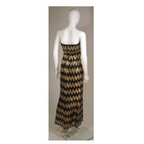 This Scaasi gown is composed of a sequined knit in black and gold hues with a zig zag pattern. There is a center back zipper and bustier foundation. In excellent great vintage condition. 