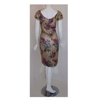 CEIL CHAPMAN Circa 1950 Floral Brocade Cocktail Dress. This is a vintage silver and gold multi-colored metallic floral print cocktail dress by Ceil Chapman, from 1950. The cocktail dress has short sleeves, a scoop neckline, and a high fitted waist.This floral print cocktail dress by Ceil Chapman is available to be viewed privately in our Beverly Hills boutique couture salon during business hours. Please telephone us with any questions or if you wish to set up a private appointment to view it personally.Plea