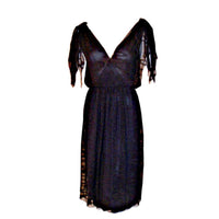 This is a navy blue three layer chiffon swirl print cocktail dress by Christian Dior Haute Couture, from the early 1980's. The dress has a deep v in the front and the back, knots at the top of each shoulder, and a side zipper with snaps. Provenance Betsy Bloomingdale