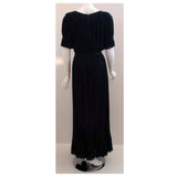 CHRISTIAN DIOR 1974 Haute Couture Pleated Chiffon Gown. This is a long black chiffon pleated gown by Christian Dior Haute Couture, from 1974. The gown has ruffles at the neckline, hem, and sleeve. It is sheer with a black satin bow tie at the waist.