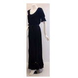 CHRISTIAN DIOR 1974 Haute Couture Pleated Chiffon Gown. This is a long black chiffon pleated gown by Christian Dior Haute Couture, from 1974. The gown has ruffles at the neckline, hem, and sleeve. It is sheer with a black satin bow tie at the waist.