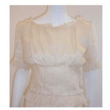 CHRISTIAN DIOR 1988 Cream Blouse & Skirt Set. This is a cream blouse and skirt set by Christian Dior Haute Couture, from 1988. The blouse and skirt are attached at the waist line by tiny couture snaps, however it can be worn as two separate pieces easily. Provenance: Betsy Bloomingdale 