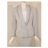 CHRISTIAN DIOR 1990s 2 pc Light Blue Skirt Suit This is a smart looking 2 piece skirt suit from Christian Dior. It is made of a light periwinkle blue wool with a matching silk lining. This suit has a fitted single button blazer with faux padded pockets, and a straight pencil skirt. Both jacket and skirt have fringed edges. Made in France