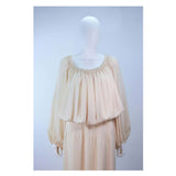 This Christian Dior gown is composed of a nude silk. Features and elastic neckline and sleeves with a pleated waist, which may be style on or off the shoulders. Comes with a slip skirt and waist belt. In vintage condition, (sold AS-IS) there is some discoloration and spotting due to age, see photos. Provenance: Betsy Bloomingdale 