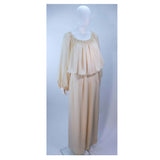 This Christian Dior gown is composed of a nude silk. Features and elastic neckline and sleeves with a pleated waist, which may be style on or off the shoulders. Comes with a slip skirt and waist belt. In vintage condition, (sold AS-IS) there is some discoloration and spotting due to age, see photos. Provenance: Betsy Bloomingdale 