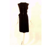CHRISTIAN DIOR Haute Couture Black Velvet Cocktail Dress. This is a custom Haute Couture cocktail dress from Christian Dior. It is a lovely fitted dress with a bow at the waist, made from a soft black velvet. There is a metal zipper down the back.Measurements: Bust: 34" Waist: 25"Hip: 34"Length: 40"