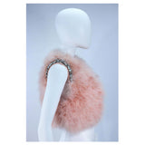 This Givenchy jacket is composed of a soft mauve pink marabou and features rhinestone jewel accents at the shoulders. The base is composed of silk and features a silk organza interior. In excellent condition. 
