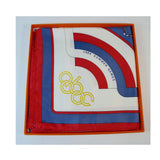 HERMES 1984 Summer Olympics Silk Scarf. Made in France of pure silk and finished by hand with finely rolled hand-stitched edges, this eye-catching Hermès scarf is 36" x 36" in size and features a 1984 Summer Olympics ABC torch and rings design.