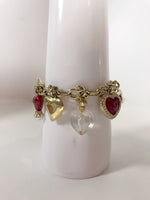 ST. JOHN Gold Toned Charm Toggle Bracelet with Hearts and Red Rhinestones