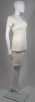 This Thierry Mugler skirt suit is composed of a white material. The jacket has a center front closures with silver hardware. The skirt has a classic pencil silhouette with zipper closure. In excellent vintage condition. Made in France.
