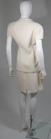 This Thierry Mugler skirt suit is composed of a white material. The jacket has a center front closures with silver hardware. The skirt has a classic pencil silhouette with zipper closure. In excellent vintage condition. Made in France.