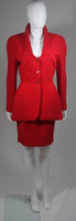 This skirt suit is composed of red fabric. The jacket has center front closures with silver hardware. The skirt has a classic pencil silhouette with zipper closure. In excellent vintage condition. Made in France.